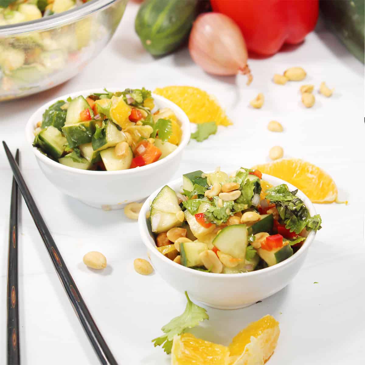 Two bowls of Thai Cucumber Salad with peanuts.