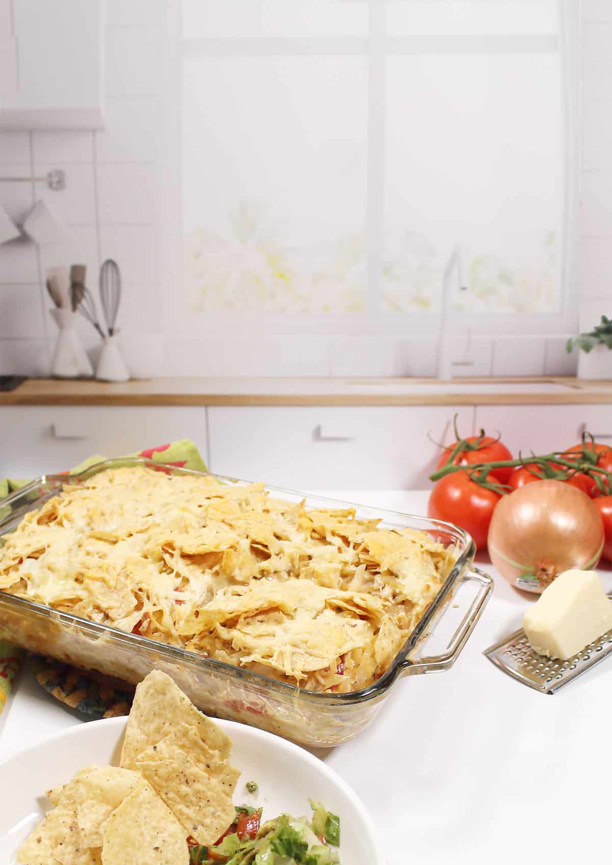 Baked southwestern chicken casserole in front of window.