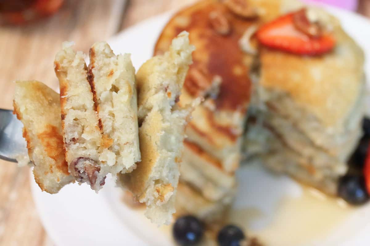Bite of pancakes on fork closeup.