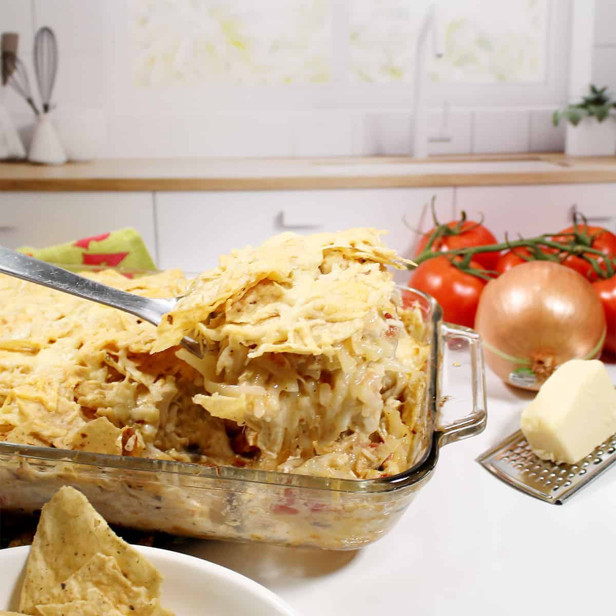 Lifting serving of casserole on spatula with window in back.