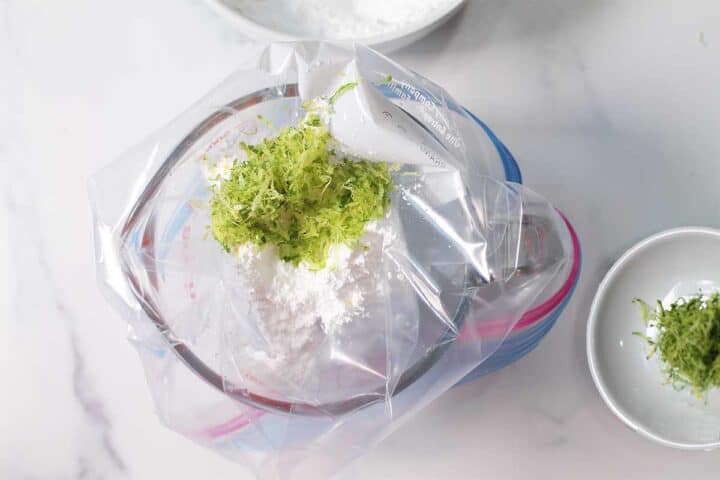 Mixing lime zest into powdered sugar.