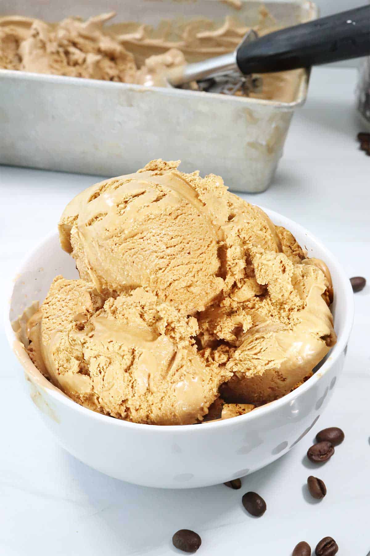 No Churn Kahlua Coffee Ice Cream in a bowl by pan.