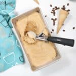 Scooping no churn coffee ice cream out of loaf pan.