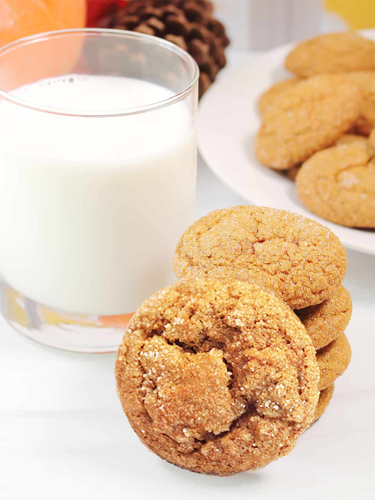 A stack of Pumpkin Spice Cookies with glass of milk.