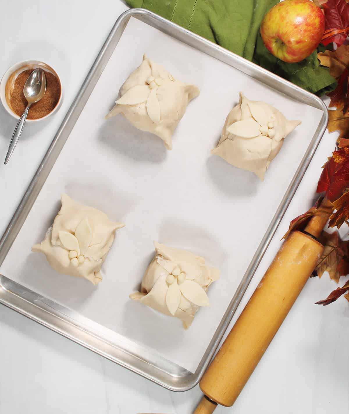 Apple dumplings on baking sheet.