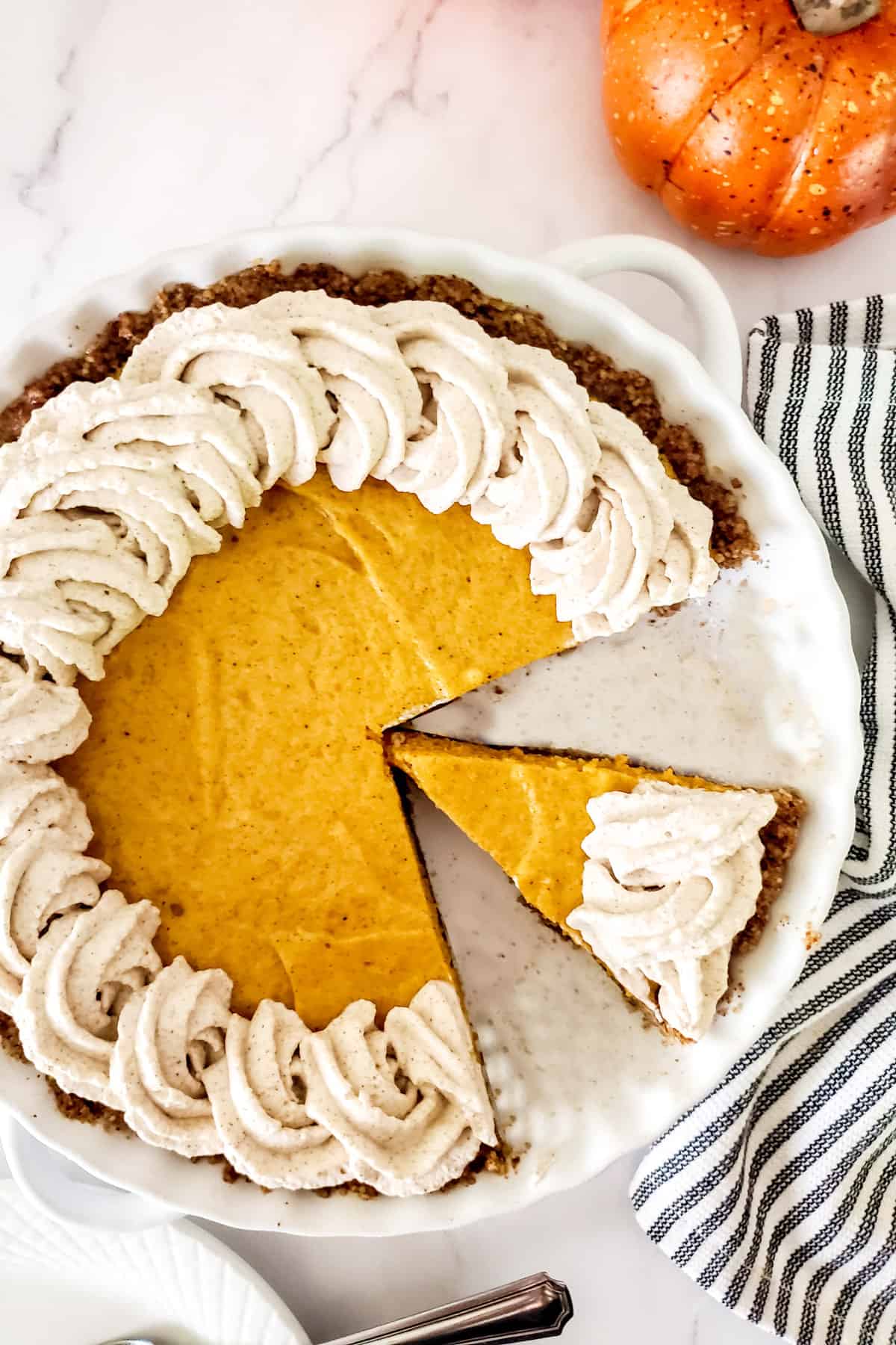 Overhead of pumpkin chiffon pie with slice out.