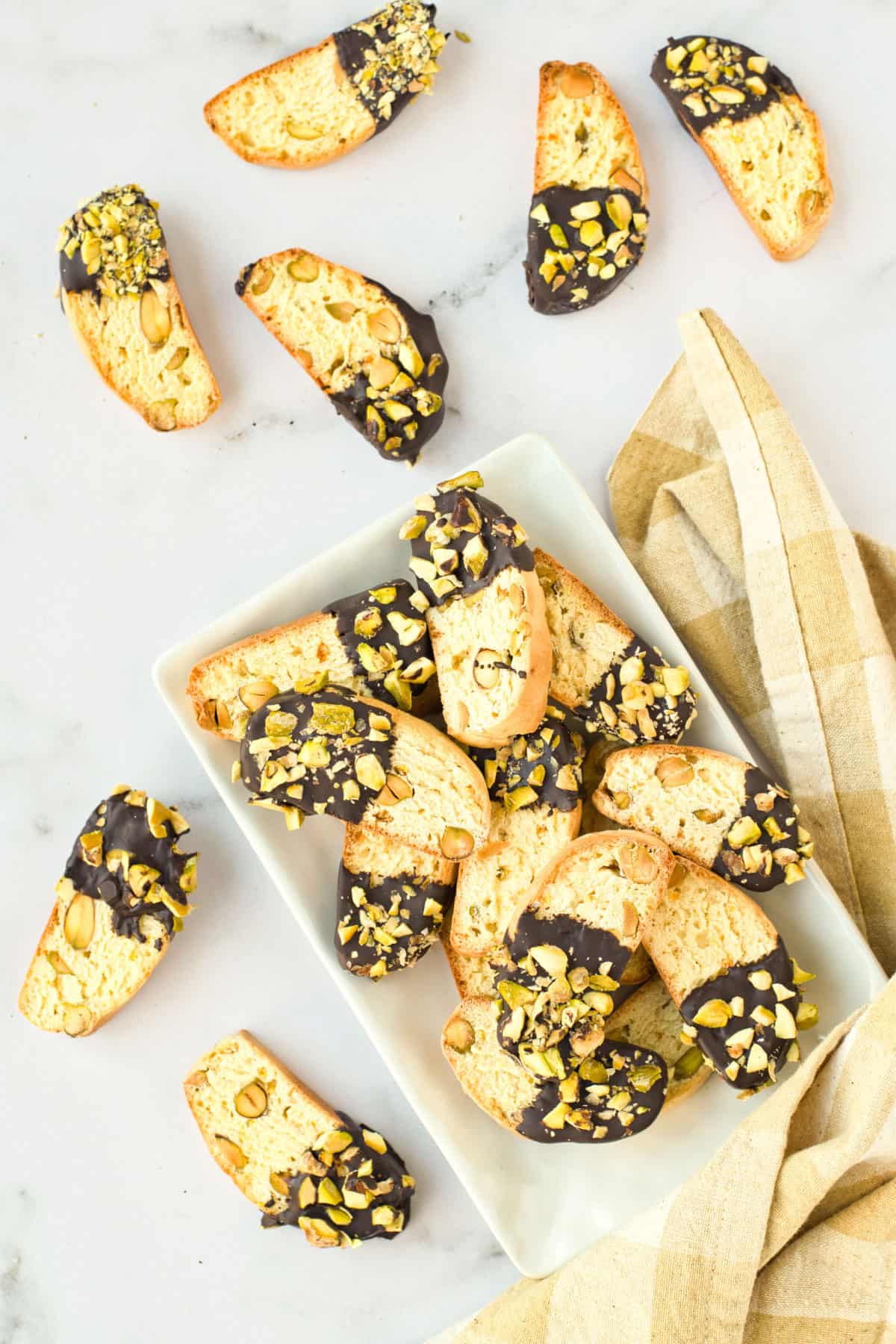 Orange pistachio biscotti with gold napkin.