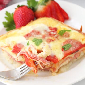 Closeup of Italian Egg Bake on white plate with bite on fork.