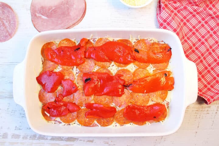 Place pepperoni and roasted peppers on top of mozzarella cheese.