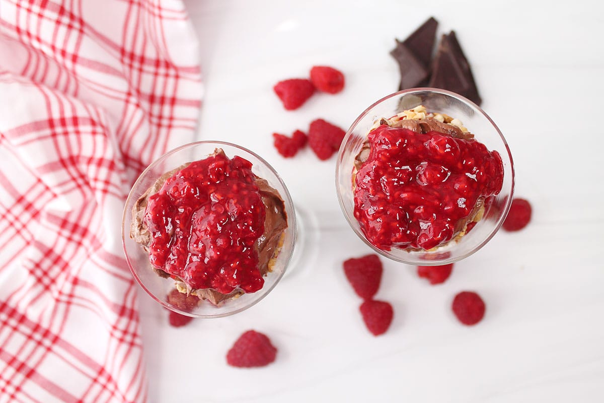 Overhead of healthy trifle with raspberries on top.