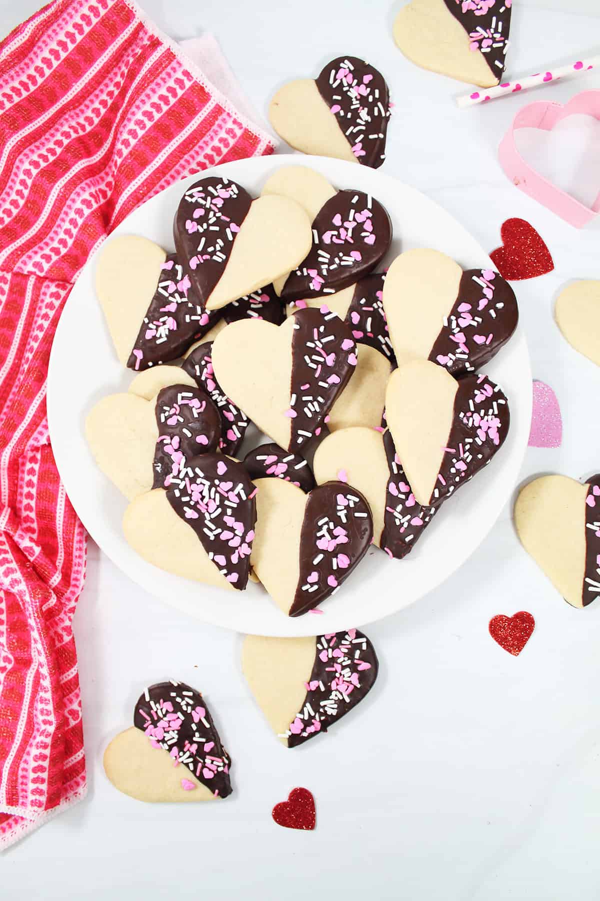 Valentine chocolate dipped heart cookies plated.