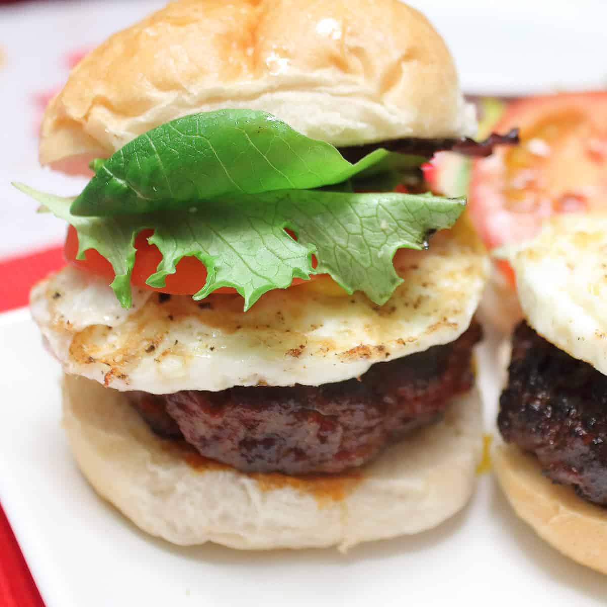 Closeup of burger with chorizo and fried egg.