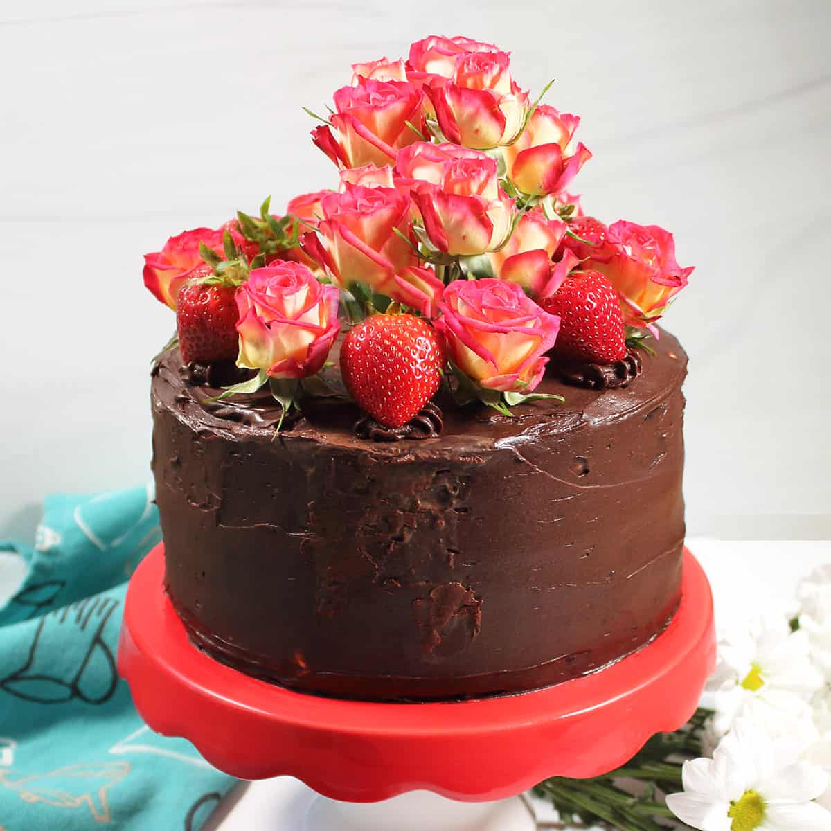 Decorated layer cake on cake stand.