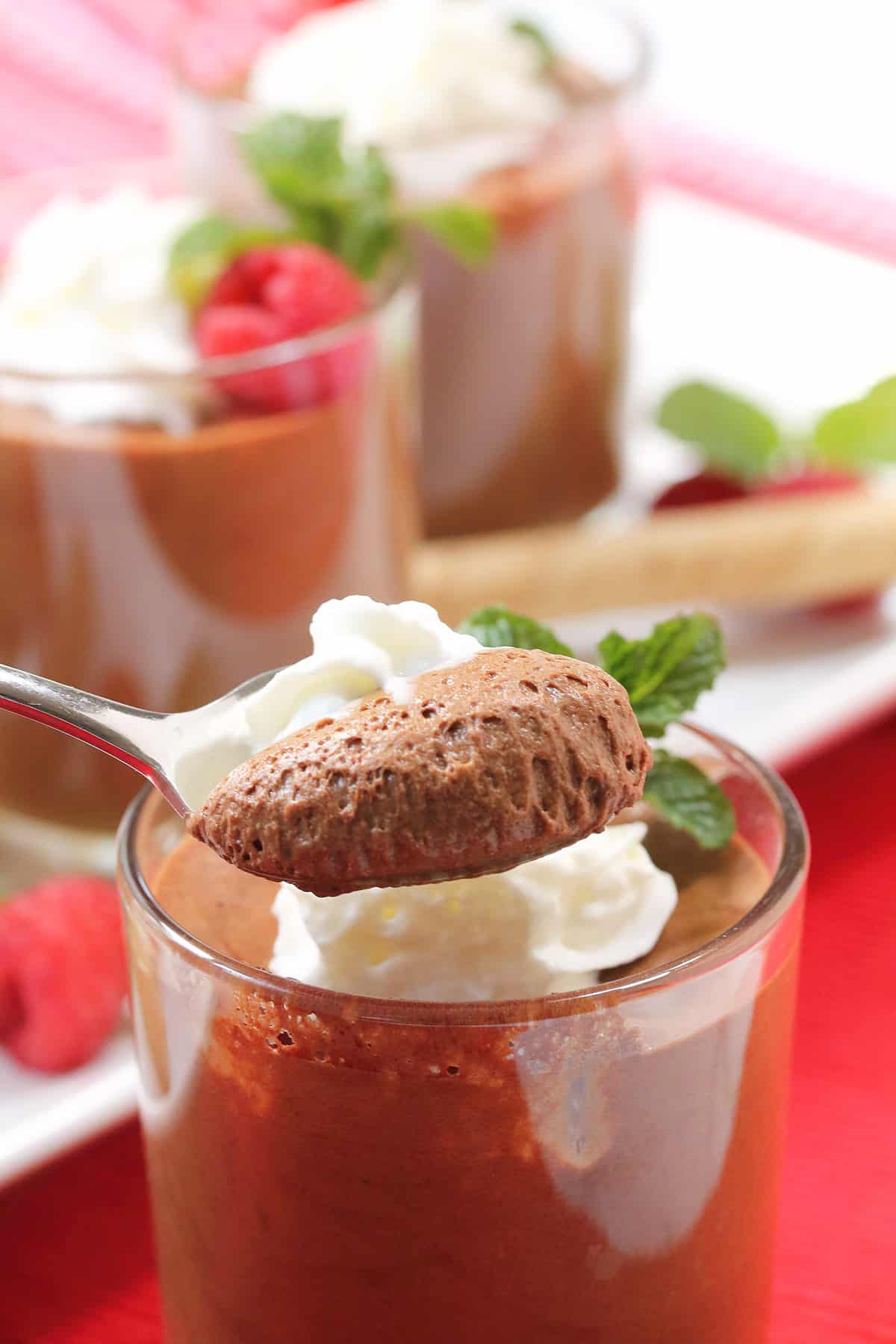 Spoonful of coffee mousse over serving dish.