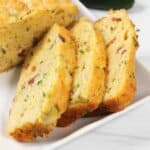 Closeup of three slices of bacon cheese bread.