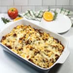 Baked casserole with serving plate in back.