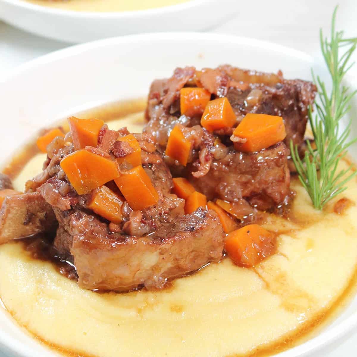 Plated Dutch oven braised short ribs dinner.