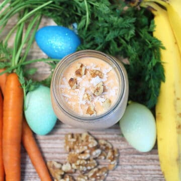 Overhead of garnished carrot cake smoothie in mason jar.