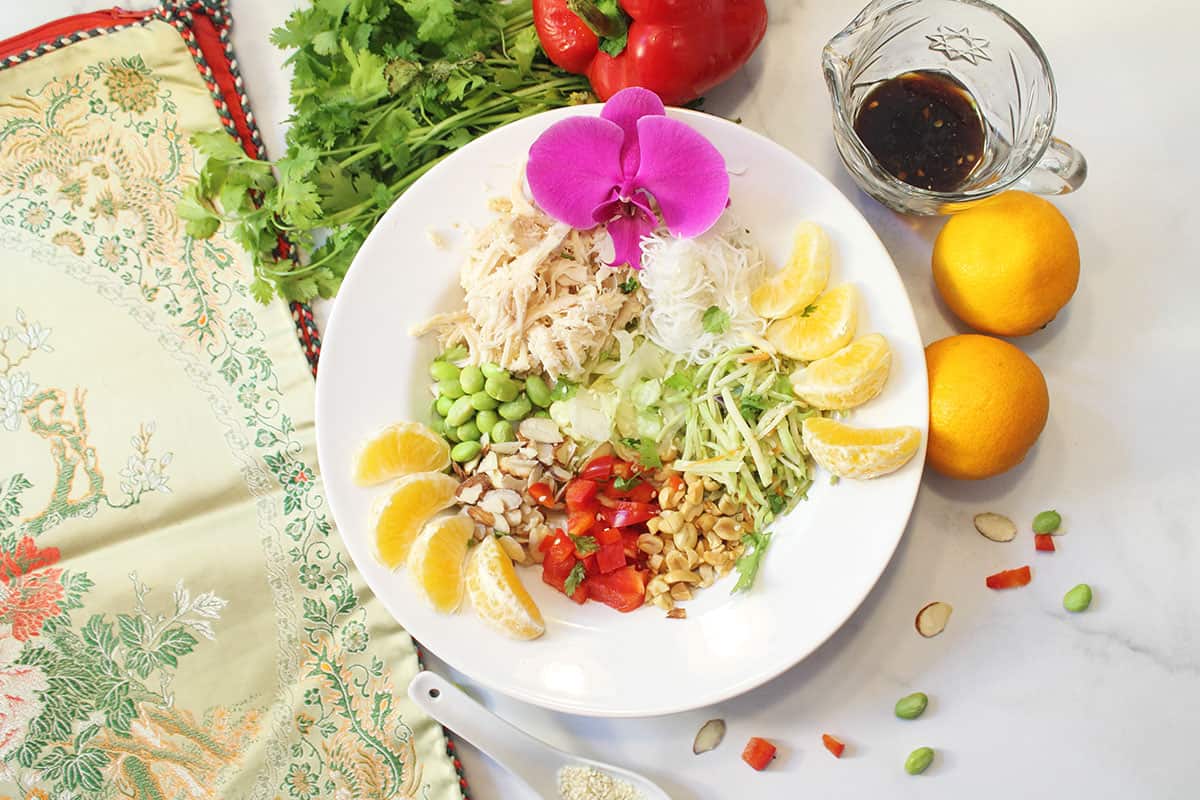 All ingredients for salad prepped in a white bowl.