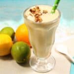 Closeup of citrus smoothie with straw.