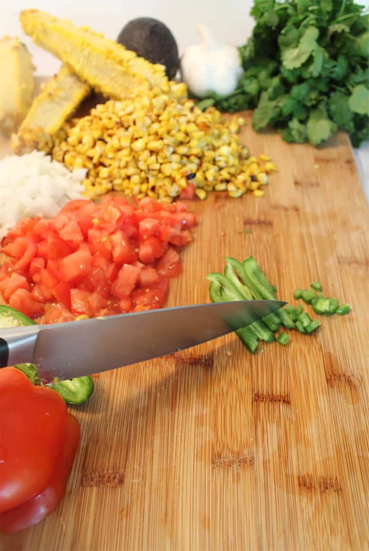Cutting the remaining vegetables for the salad.