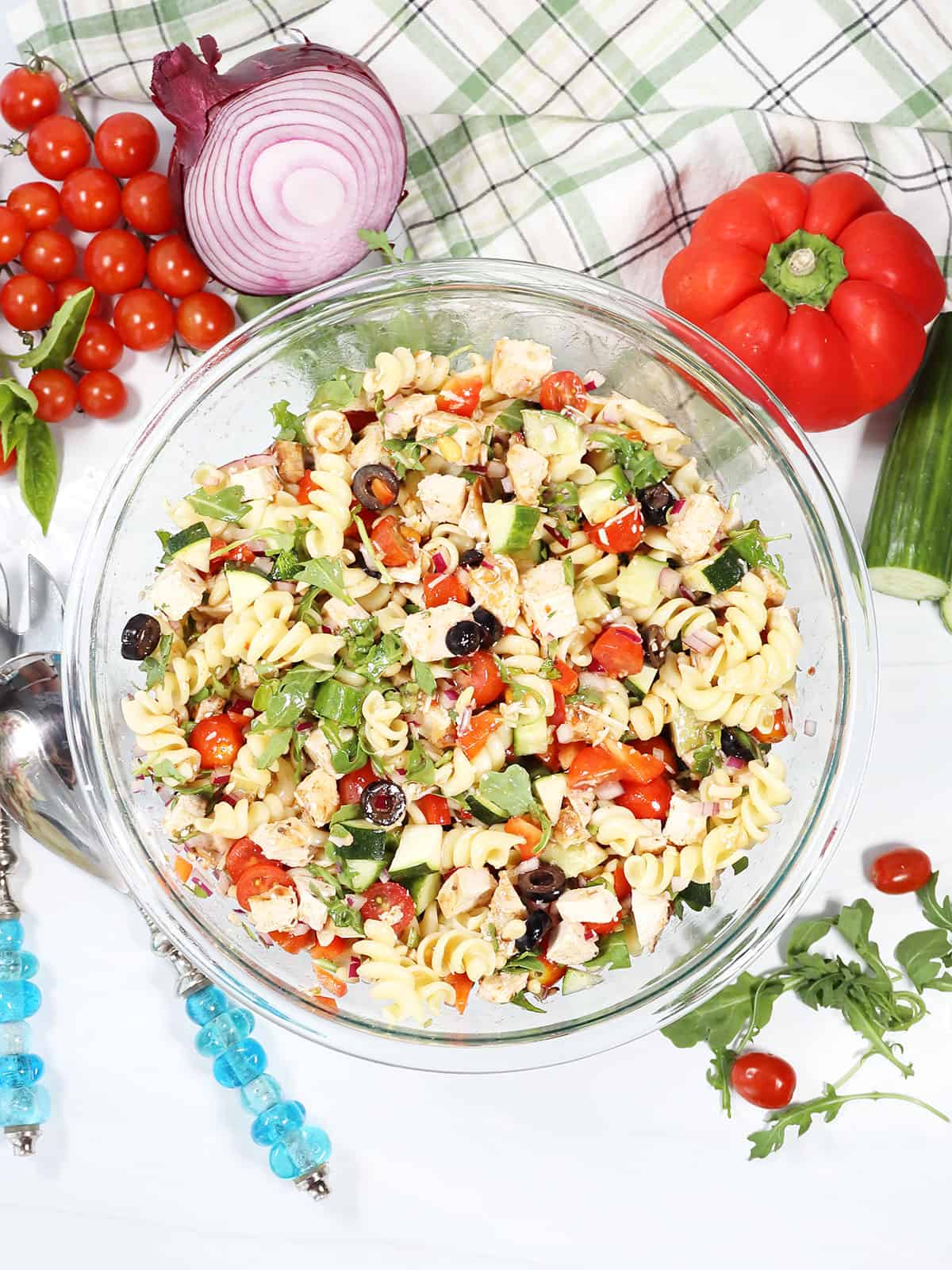 Summer Chicken Pasta Salad in bowl with ingredients around it.