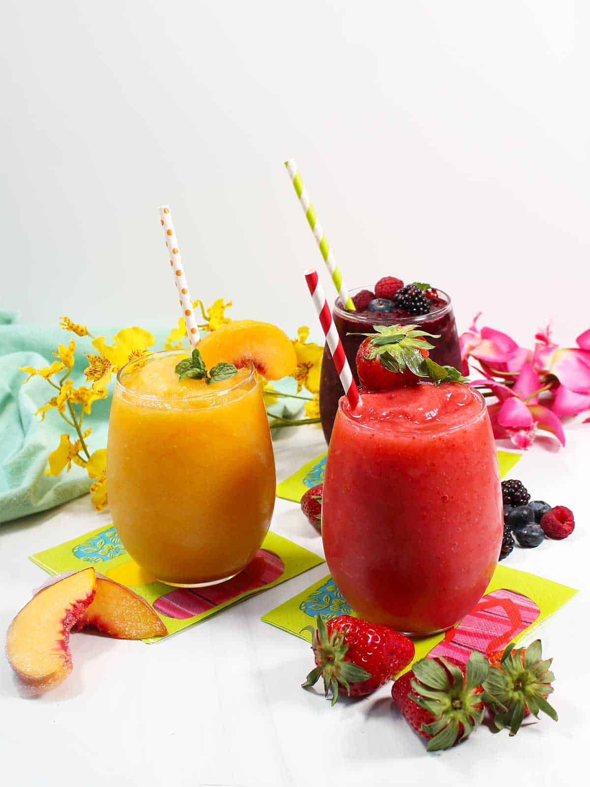 Fruit slushies with straws.