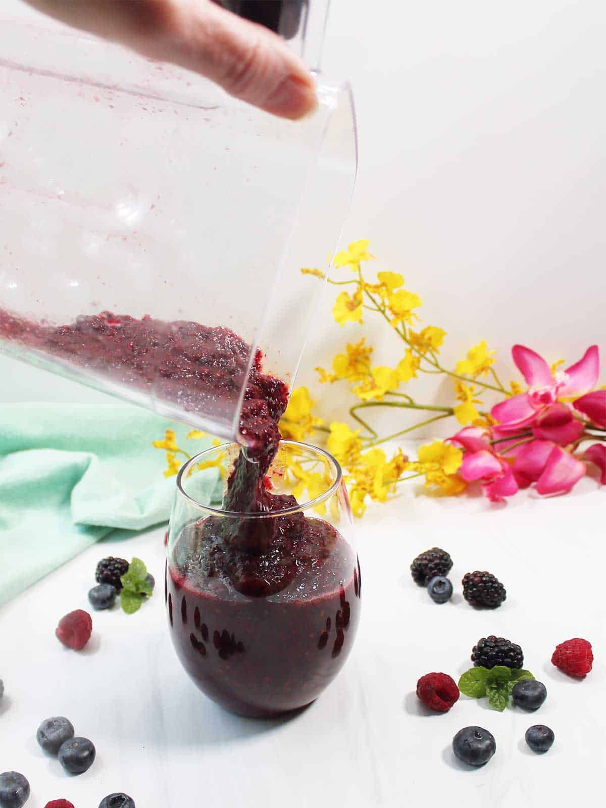 Pouring wine slushie into glass.