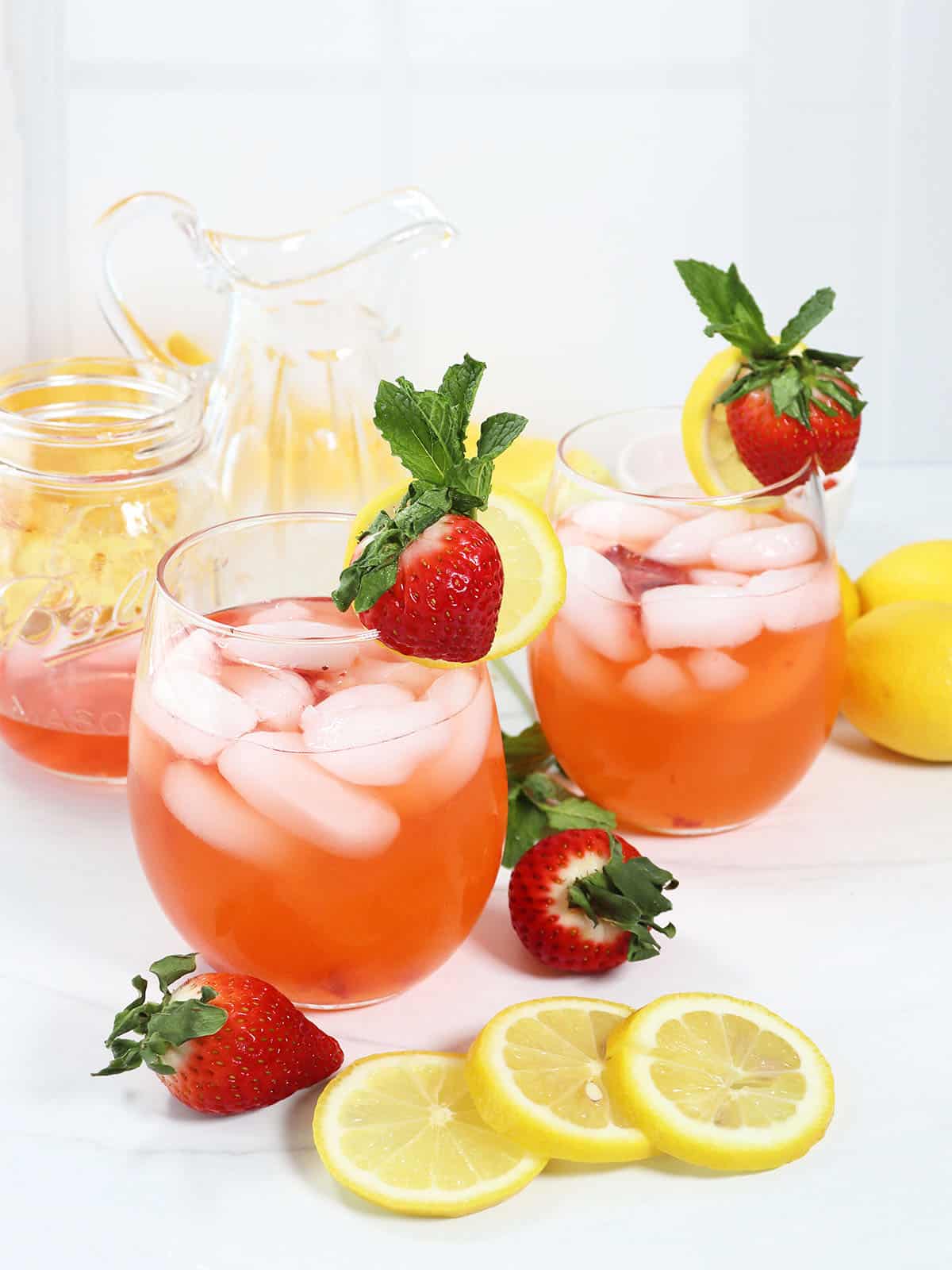 Two garnished Strawberry Lemonade Cocktails.