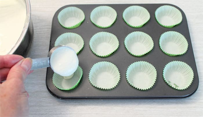 Pouring key lime filling into cupcake liners.