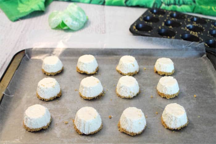 Frozen bites removed from cupcake pan and placed on cookie sheet.