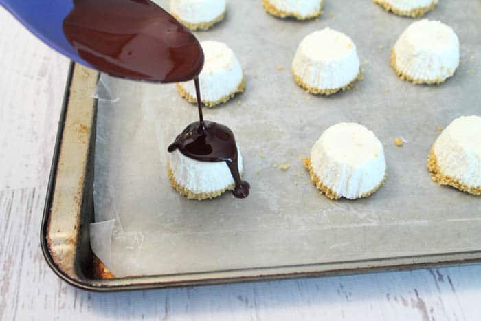 Covering bites with melted chocolate.