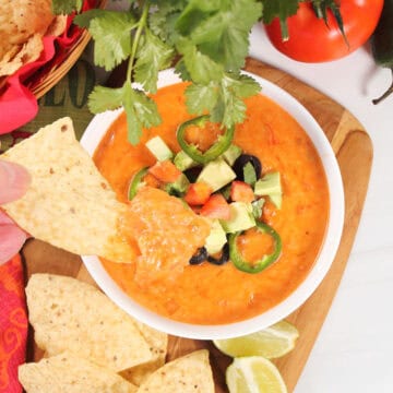 Dipping into Spicy Queso Cheese Dip.