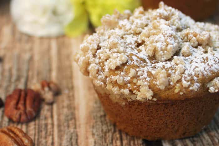 closeup of pumpkin muffin on wooden table.