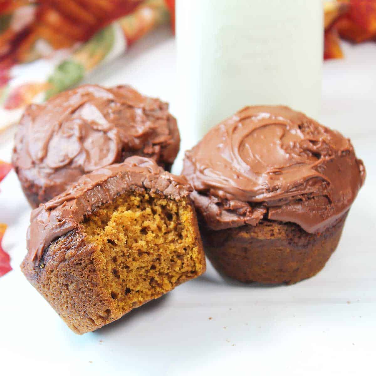Bite out of Pumpkin Nutella Muffin by milk bottle.
