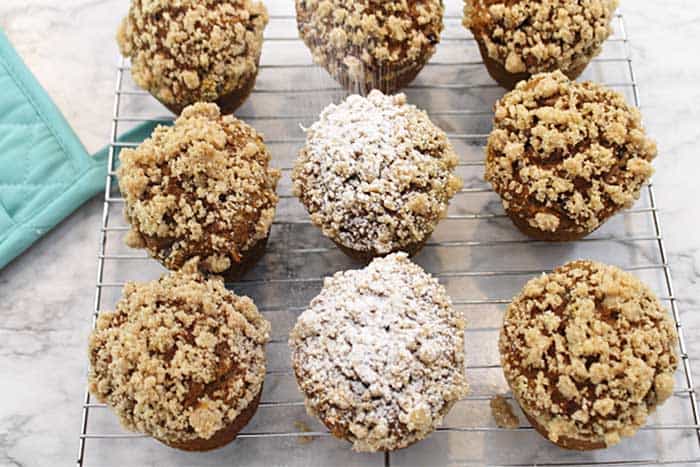 Shaking on powdered sugar on cooled muffins.