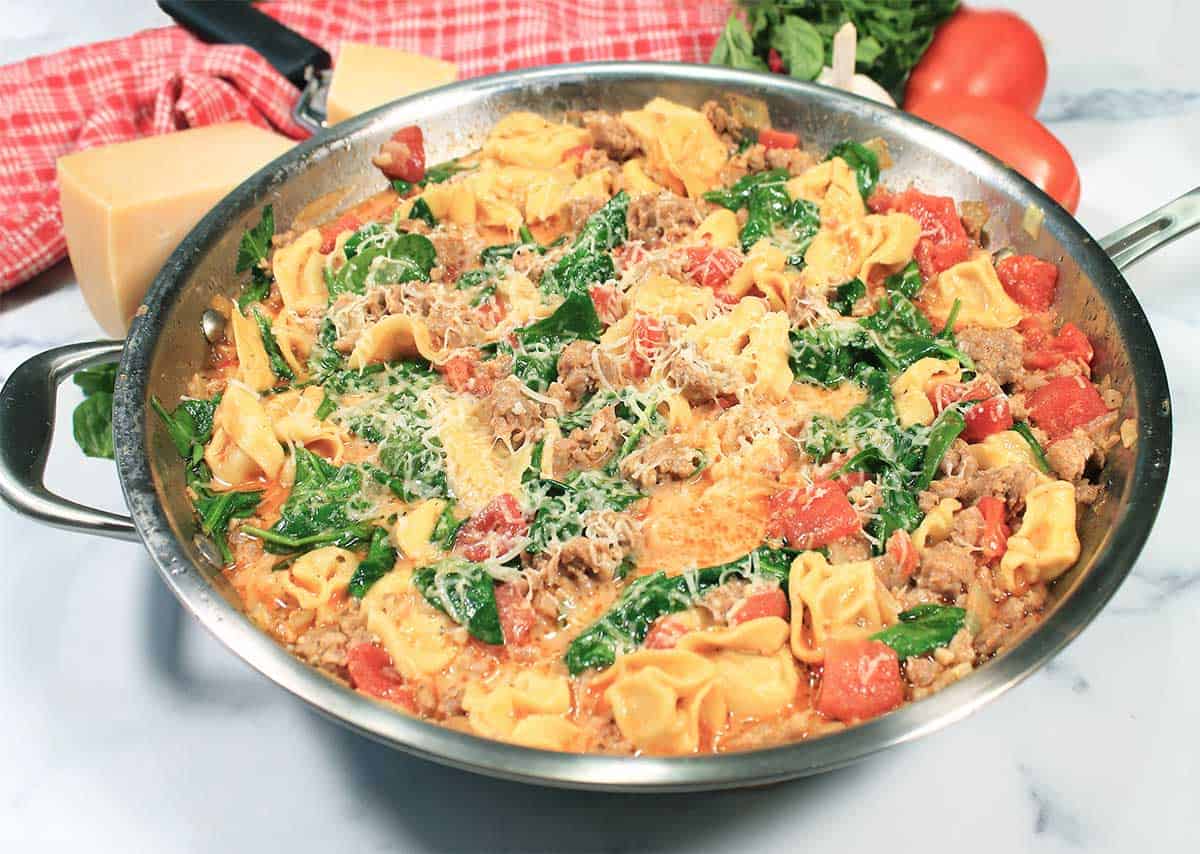 Finished tortellini and sausage in skillet.