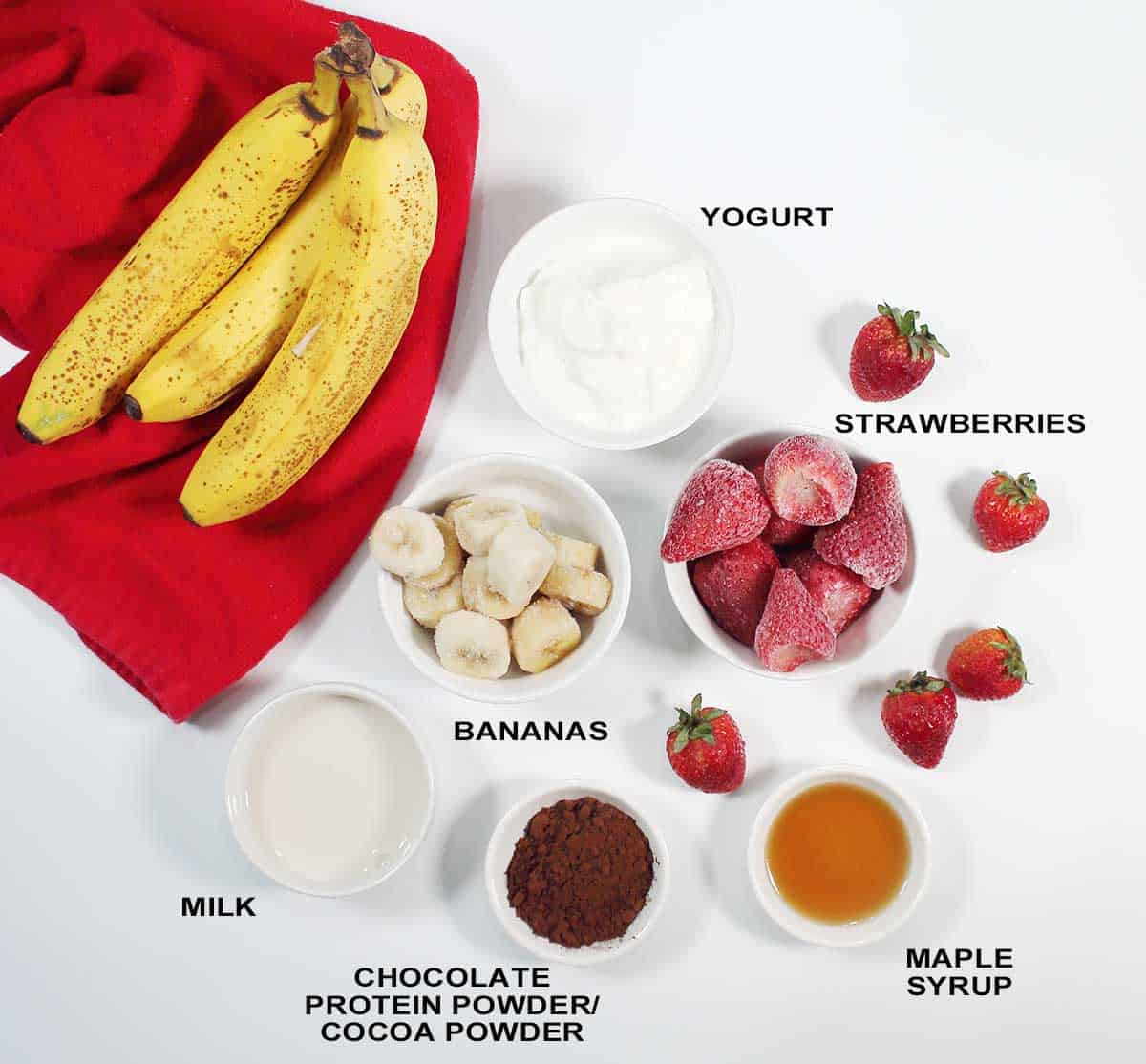 Ingredients for chocolate strawberry banana smoothie.