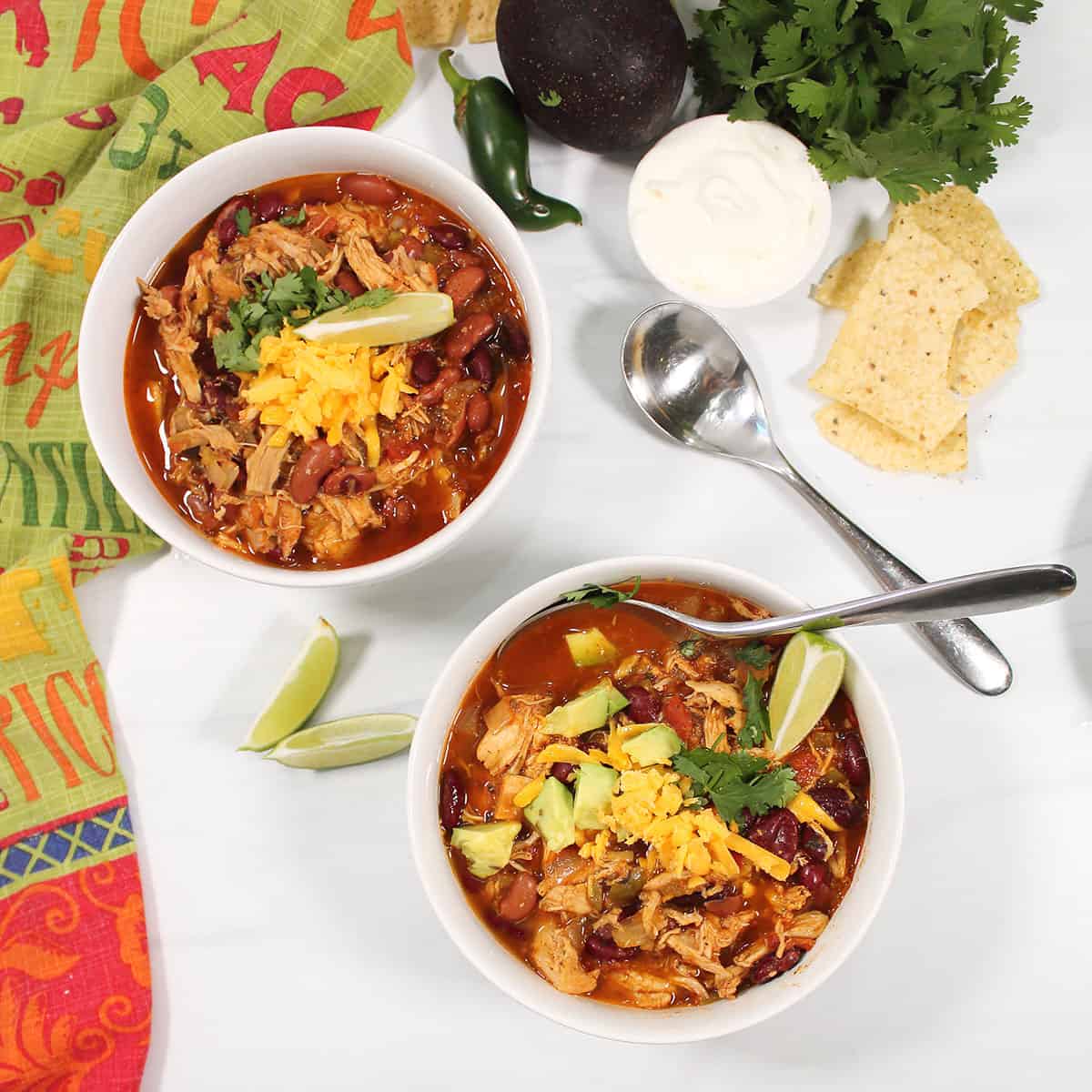 Overhead of two bowls of chili.