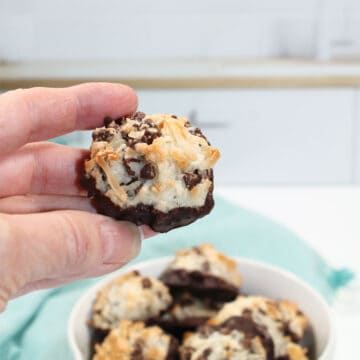 Holding a chocolate chip macaroon.