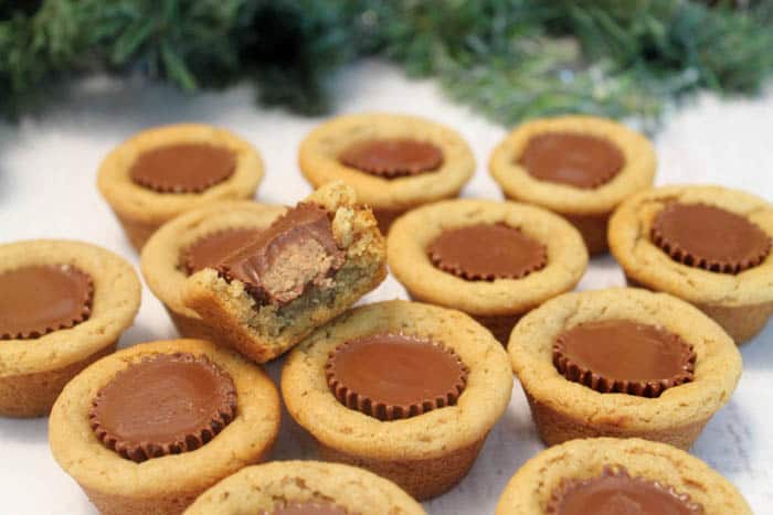 A grouping of finished cookies with a bite taken out of top one.