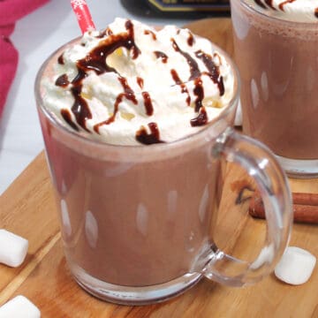 Closeup of mug of Mexican Hot Chocolate with garnish of whipped cream.
