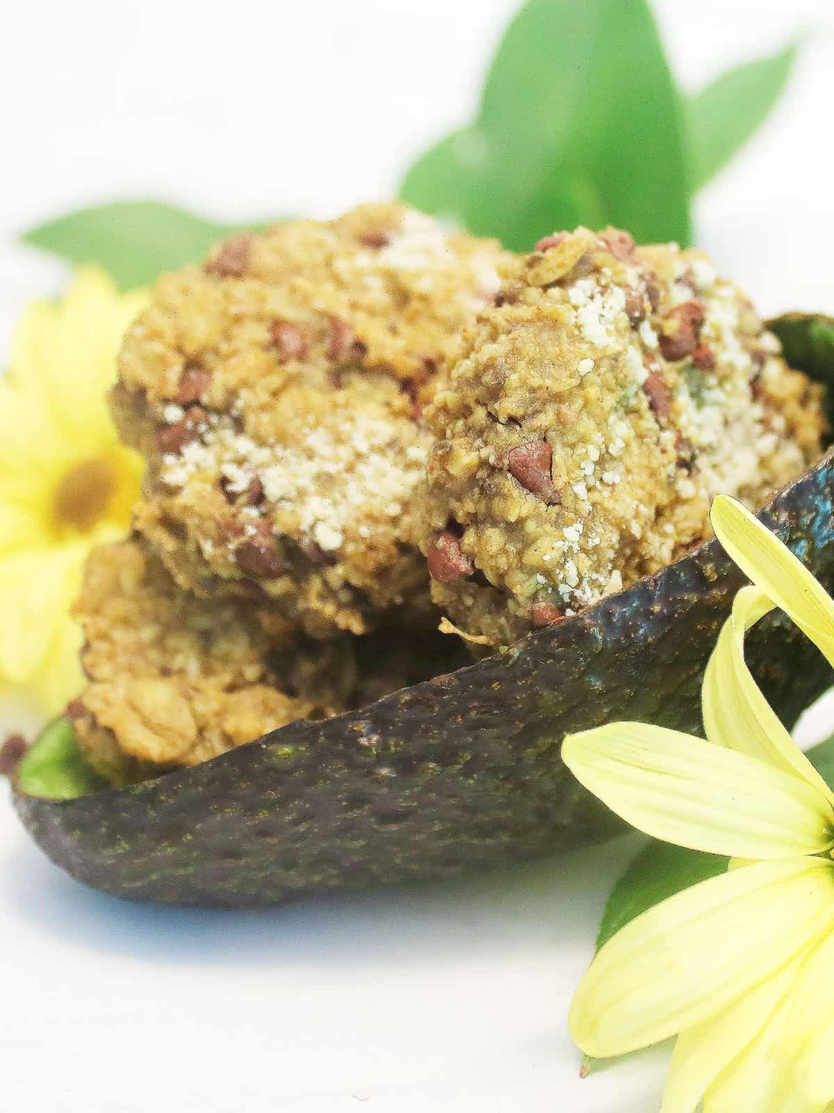 Gluten-free oatmeal chocolate chip cookies in halved avocado rind.