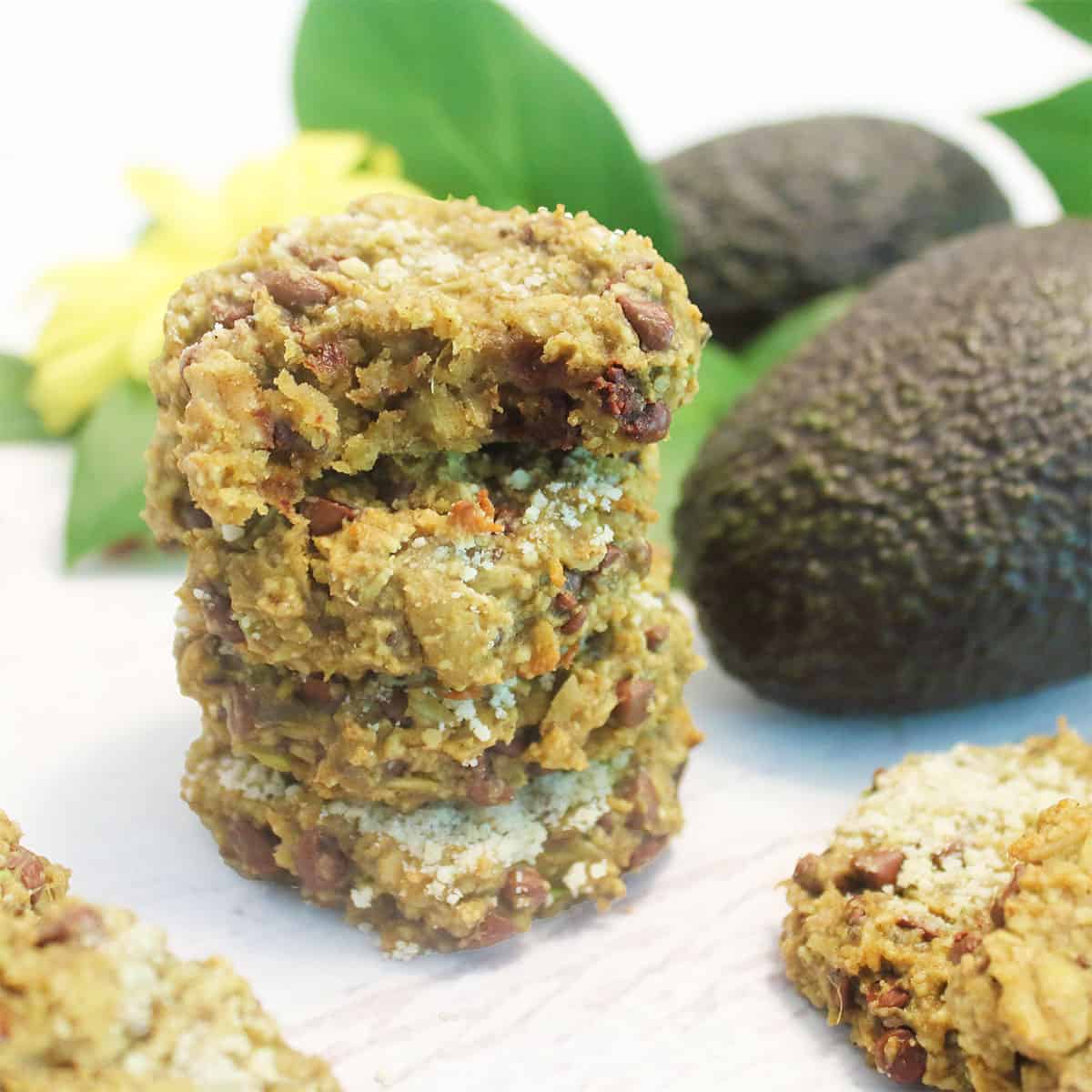 Stacked vegan oatmeal chocolate chip cookies with avocado.