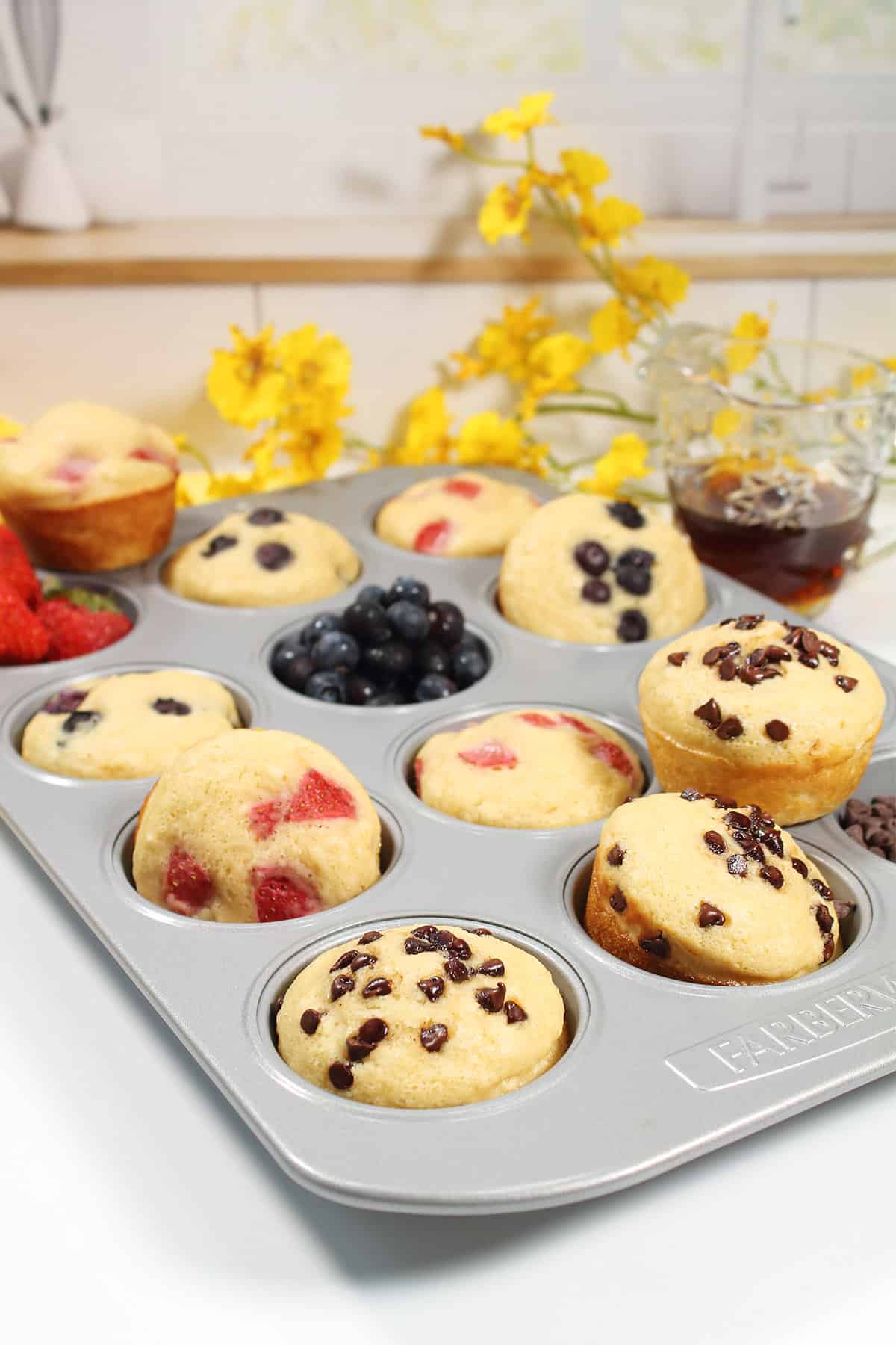 Easy pancake muffins on muffin tin with chocolate chips and blueberries.