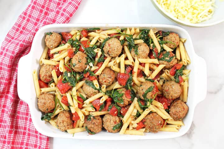 Final layer of meatballs on top of cheese.