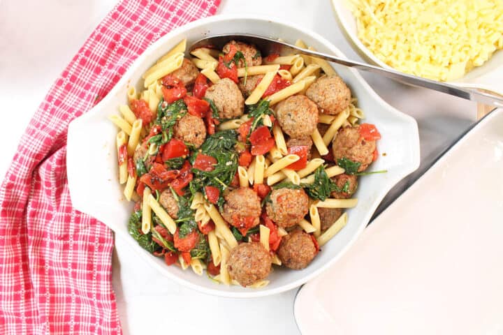Mix meatballs and pasta with tomato sauce.