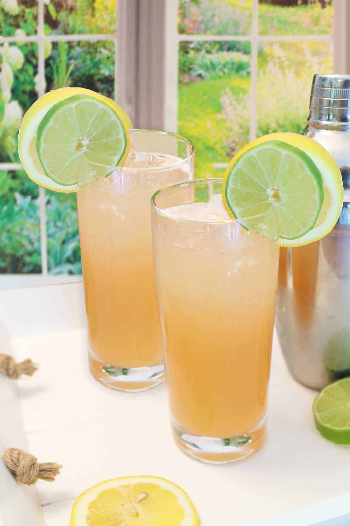 Two grapefruit tequila cocktails on tray ready to serve.
