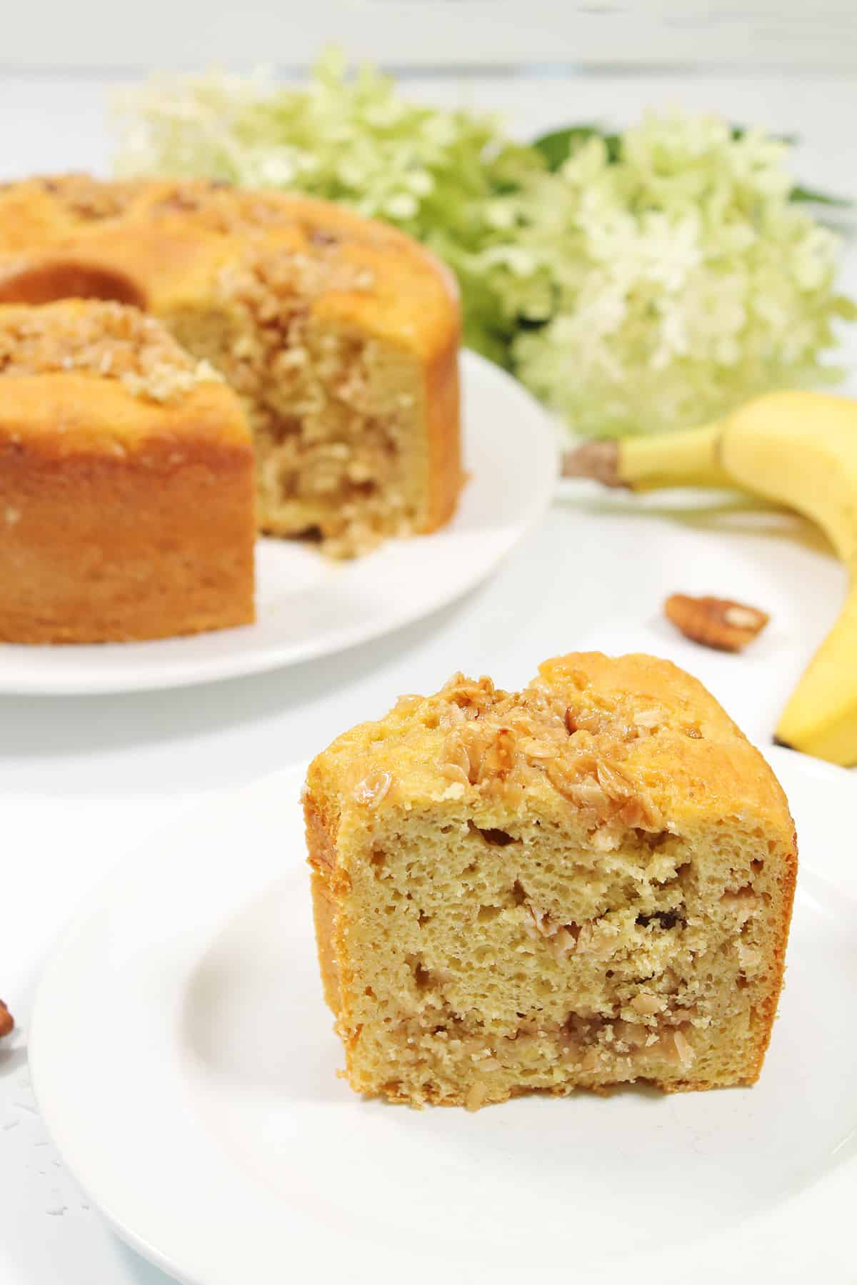 Slice of cake in front of bundt cake.