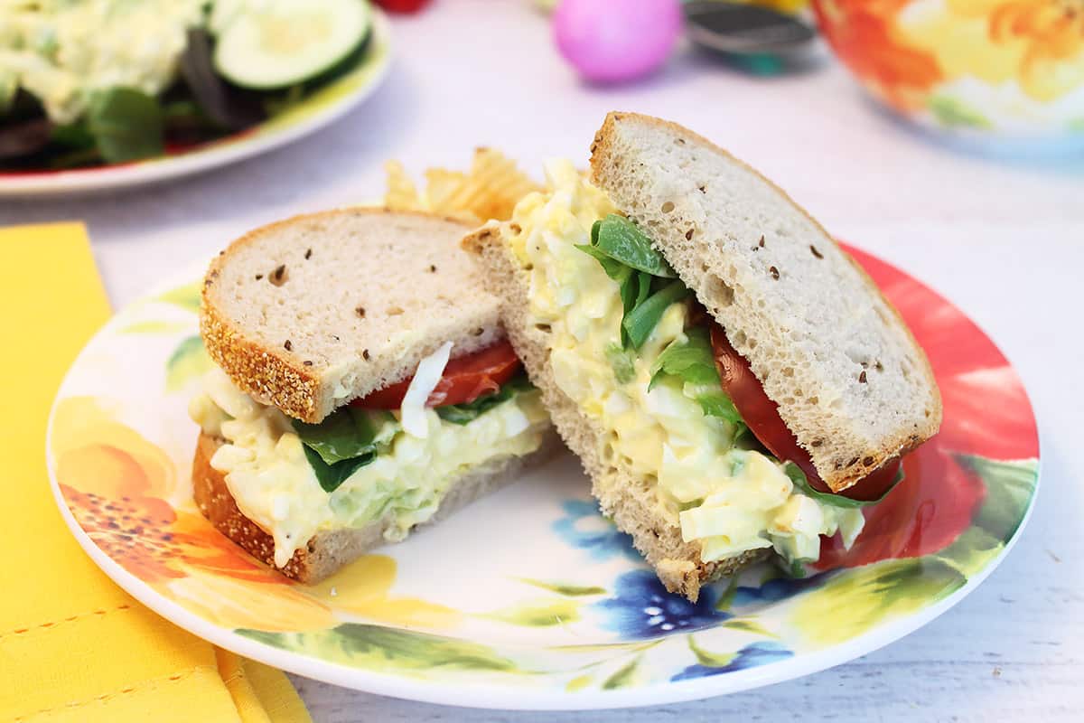 Egg salad sandwich on plate.